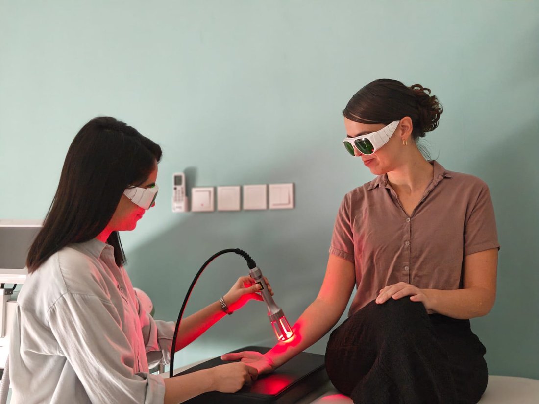Class 4 laser therapy applied to a forearm